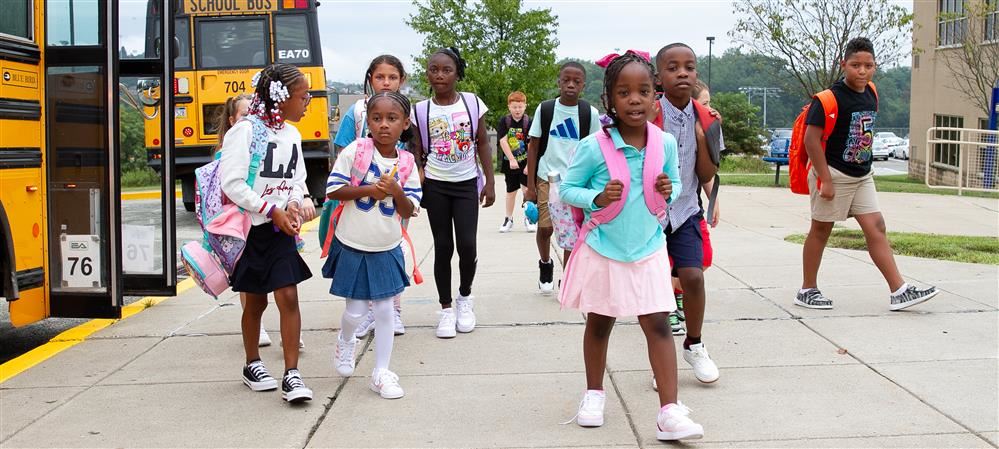 Group of Logan students exit school bus