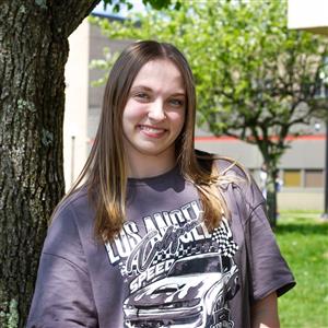  Photo of Addison in front of a tree