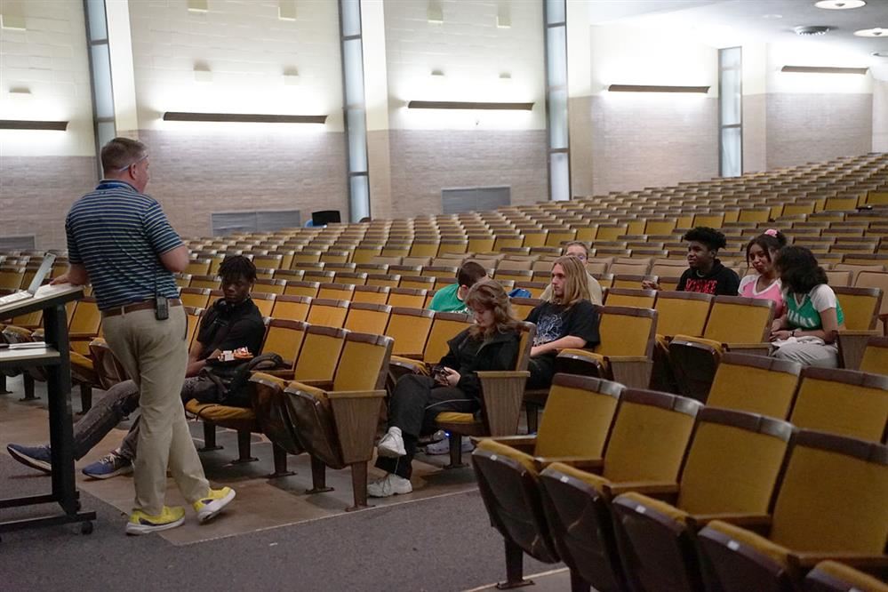  EA principal R.J. Long meets with students in the auditorium.