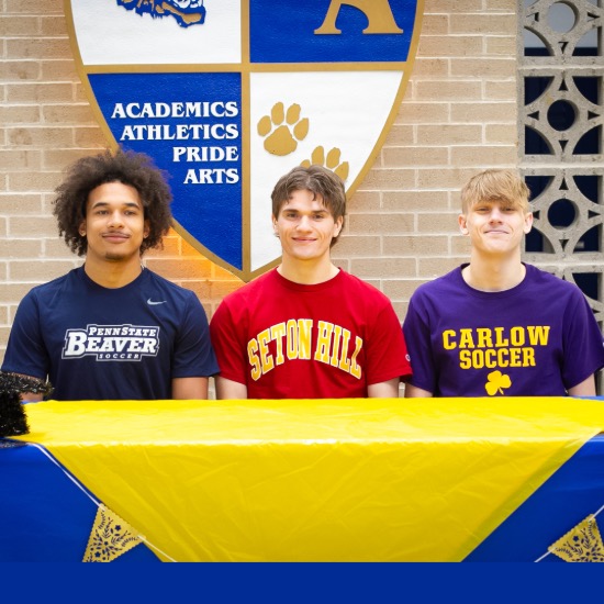   Three students seated at long table