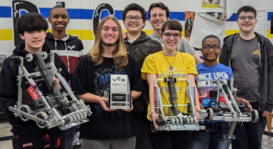  Group of robotics students holding their robots